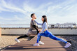© Iryna - warm up training do lunges exercise on rooftop outdoor on rooftop in summer day morning