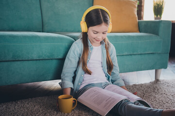 Poster - Portrait of cute little girl sit floor read book wear shirt loft interior modern flat indoors