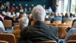 © Thanos - Elderly Participant Seen from Behind at Town Hall Meeting