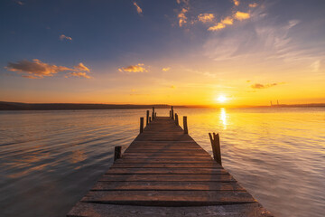 Wall Mural - sunset over the lake and old fishing wooden pier