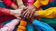 © svastix - A vibrant image depicting a group of diverse and colorful hands stacked together, symbolizing unity, diversity, and teamwork among people from different backgrounds.