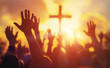 © Curioso.Photography - Hands raised in worship in front of a cross at sunset.