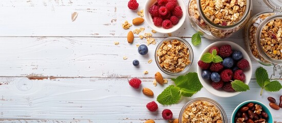 Aufkleber - Variety of ingredients for a nutritious breakfast include homemade granola in a glass jar fruit nuts and mint on a white wooden surface Top view with a blank space for an image. Creative banner