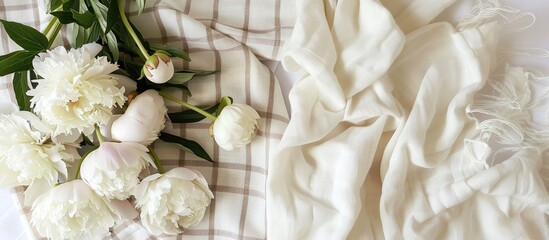 Poster - A summer themed flat lay with white peonies and a checkered linen plaid set on a white background featuring a healthy garden tea time picnic concept along with ample copy space for a text or image