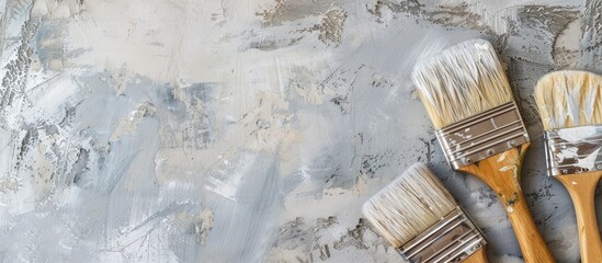 Poster - A white and gray background with paintbrushes depicting repair design creativity and art concepts in a top view copy space image