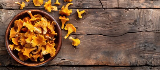 Poster - Fresh chanterelle mushrooms make a delicious snack on the rustic table with a copy space image background in a top view