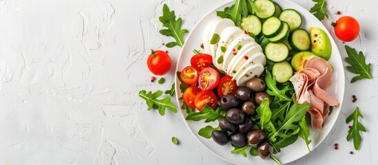 Sticker - Keto dinner plate with boiled pork avocado guacamole tomatoes cucumbers mozzarella olives and arugula on a white table Detox and health concept Shot from the top showing a copy space image