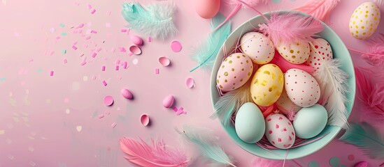Aufkleber - Top view of a white bowl holding Easter eggs and feathers against a bright background with copy space for an image
