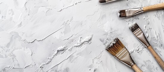 Poster - A white and gray background with paintbrushes depicting repair design creativity and art concepts in a top view copy space image