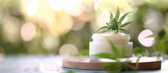 Poster - Moisturizing cream in jar featuring hemp leaf decoration against a blurred backdrop ideal for skin care labeled as natural cosmetics with a copy space image