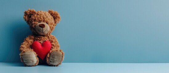 Poster - A teddy bear and a heart set on a blue background perfect as a Valentine s Day gift with ample copy space image available