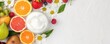 © Navaporn - Flat lay of foam hydrating scrub surrounded by fresh fruits and flowers, natural beauty, skincare inspiration