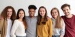 © Iryna - A cheerful, diverse group of college students, including teenagers, pose together smiling in a casual setting.