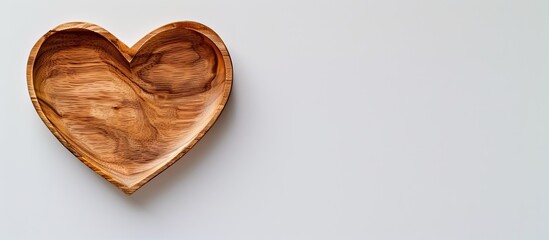 Leinwandbilder - Heart shaped wooden plate on a white backdrop with space for text or images conveying a Valentine s Day theme. Creative banner. Copyspace image