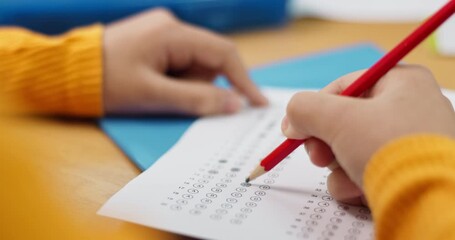 Poster - Hands, writing and exam for kid, education and student in classroom with paper, knowledge and scholarship. Desk, pencil and child with information for project, multiple choice or answer for questions