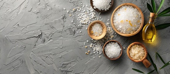 Poster - A spa set featuring mineral salt and oil placed on a grey background with ample copy space image available