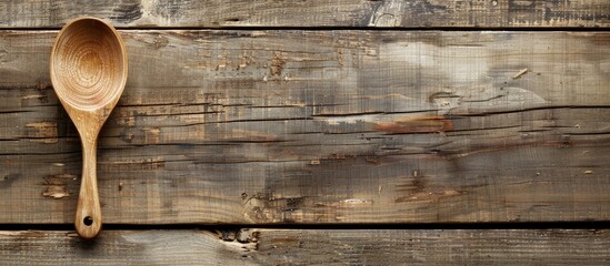 Sticker - A large wooden spoon displayed against a wooden backdrop with copy space image