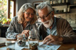 © Nart - An elderly couple counts coins at a table. Saving money for retirement