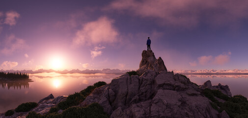 Wall Mural - adventure man hiker high in mountains. landscape in background. sunset.