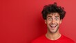 © Trushchenko_O - A man with a red shirt and curly hair is smiling and looking at the camera. The image has a happy and cheerful mood