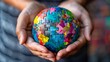 © Chronicles Artsy  - Hands Holding a Colorful Puzzle Globe