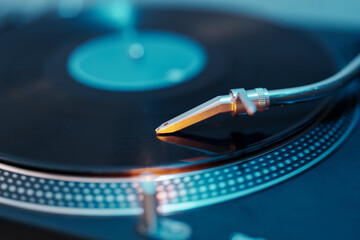 A detailed view of a turntable needle on a vinyl record, capturing the essence of analog music.