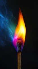 Lit matchstick with colorful flame, close-up. Abstract and conceptual photography concept