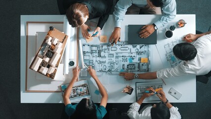 Wall Mural - Top aerial view of project manager or civil engineer writing at blueprint and planning building design. Aerial view of architect working together at meeting table with document placed. Alimentation.