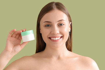 Poster - Beautiful woman with jar of cream on green background, closeup