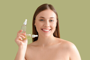 Poster - Beautiful woman with bottles of serum on green background, closeup