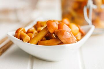 Wall Mural - Pickled nameko mushrooms.Traditional japanese mushrooms in bowl on white table.