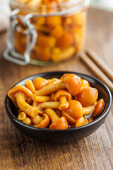 Wall Mural - Pickled nameko mushrooms.Traditional japanese mushrooms in bowl on wooden table.