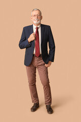 Sticker - Handsome happy mature man in stylish formal suit with tie on beige background