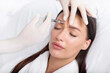 © Home-stock - Young woman recieving injection of anti-aging botox filler to forehead from professional cosmetologist in beauty salon