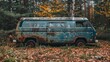 © FryArt - Abandoned van surrounded by trees and fall foliage in a quiet forest