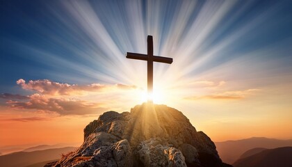 christian cross on top rock mountain with bright sunbeam on the colorful sky background christian background concept