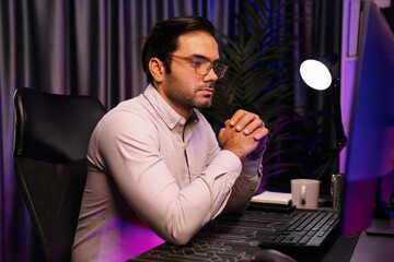 Working smart IT developer analyzing data software development on two pc screen, creating application program updated version online website page system online at neon light cyber office. Surmise.