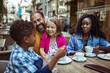 © Vorda Berge - Happy multiethnic family enjoying time at a cafe together