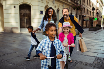 Wall Mural - Joyful diverse family having fun on a city walk