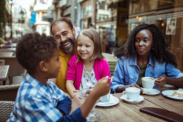 happy multiethnic family enjoying time at a cafe together