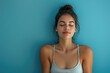 © darshika - Woman meditating over blue background