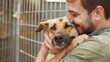 © Sophia - Male volunteer hugging dog in shelter