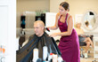 © JackF - Young female hairdresser working hair clipper with older man