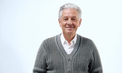 Wall Mural - Group portrait video of a tender Russian man in his 60s wearing a chic cardigan against a white background 