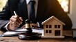 © Dzikrul Husnani - Male judge sitting at desk with gavel and small wooden toy house, working with documents, signing contract agreements. Real estate law, divorce property, house foreclosure and bankruptcy concept, ai