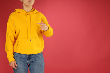 Sticker - A young woman in a yellow hooded sweatshirt