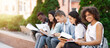 © Prostock-studio - Studying Together. Cheerful African American Student Girl Preparring For Exams Outdoors With Her University Friends, Selective Focus