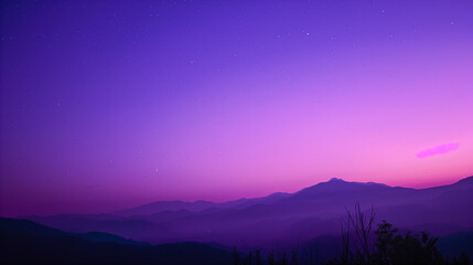 purple sky with a few stars above a mountain range