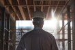 © Fitry - Construction Worker Looking at a Building Under Construction