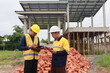 © ผดุงศักดิ์ กิจมานะทร - A male engineer, wearing a hardhat and helmet, examines blueprints on a construction site. Working as an architect and contractor, he oversees the development and renovation of buildings